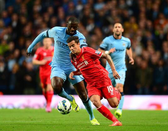 Philippe Coutinho of Liverpool tussles with Yaya Toure of Manchester City - Barclays Premier League - Manchester City vs Liverpool - Etihad Stadium - Manchester - England - 25th August 2014 - Pic Simon Bellis Sportimage EDITORIAL USE ONLY. No use with unauthorised audio, video, data, fixture lists, club league logos or live services. Online in-match use limited to 120 images, no video emulation. No use in betting, games or single club league player publications.