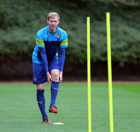 Arsenal s Per Mertesacker in action during training - Champions League Training - London Colney - London - England - 26th August 2014 - Picture David Klein Sportimage EDITORIAL USE ONLY. No use with unauthorised audio, video, data, fixture lists, club league logos or live services. Online in-match use limited to 120 images, no video emulation. No use in betting, games or single club league player publications.