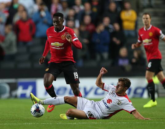 MK Dons Darren Potter tussles with Manchester United s Danny Welbeck - Capital One Cup, Second Round - Milton Keynes Dons FC vs Manchester United (ManU) - Milton Keynes - England - 26th August 2014 - EDITORIAL USE ONLY. No use with unauthorised audio, video, data, fixture lists, club league logos or live services. Online in-match use limited to 120 images, no video emulation. No use in betting, games or single club league player publications.