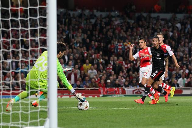 Arsenal s Alexis Sanchez scoring his sides opening goal - UEFA Champions League, Play-off Second Leg - Emirates Stadium - England - 27th August 2014 - Picture David Klein Sportimage EDITORIAL USE ONLY. No use with unauthorised audio, video, data, fixture lists, club league logos or live services. Online in-match use limited to 120 images, no video emulation. No use in betting, games or single club league player publications.