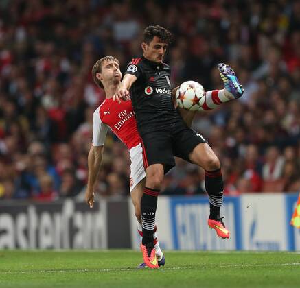 Arsenal s Nacho Monreal tussles with Besiktas Mustafa Pektemek - UEFA Champions League, Play-off Second Leg - Emirates Stadium - England - 27th August 2014 - Picture David Klein Sportimage EDITORIAL USE ONLY. No use with unauthorised audio, video, data, fixture lists, club league logos or live services. Online in-match use limited to 120 images, no video emulation. No use in betting, games or single club league player publications.