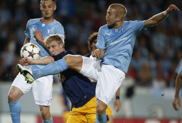SOCCER - CL, Malmoe vs RBS MALMOE,SWEDEN,27.AUG.14 - SOCCER - UEFA Champions League, play off, Malmoe FF vs Red Bull Salzburg. Image shows Markus Rosenberg (Malmoe), Martin Hinteregger (RBS) and Anton Tinnerholm (Malmoe). 