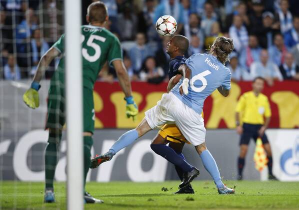SOCCER - CL, Malmoe vs RBS MALMOE,SWEDEN,27.AUG.14 - SOCCER - UEFA Champions League, play off, Malmoe FF vs Red Bull Salzburg. Image shows Alan de Carvalho (RBS) and Markus Halsti (Malmoe). 