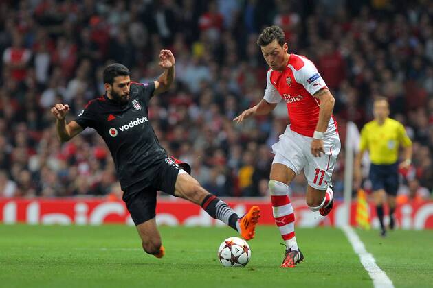 UEFA Champions League playoff second leg match match between Arsenal and Besiktas at Emirates stadium in London, Englandl August 27, 2014. Pictured: Mesut Ozil of Arsenal and Ismail Koybasi of Besiktas. 