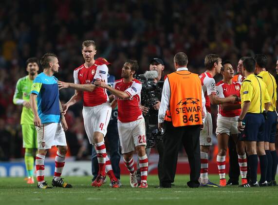 Arsenal s Mathieu Debuchy comes on to speak to referee Pedro Proenca at the final whistle - UEFA Champions League, Play-off Second Leg - Emirates Stadium - England - 27th August 2014 - Picture David Klein Sportimage EDITORIAL USE ONLY. No use with unauthorised audio, video, data, fixture lists, club league logos or live services. Online in-match use limited to 120 images, no video emulation. No use in betting, games or single club league player publications.