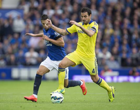 Kevin Mirallas of Everton chases Cesc Fabregas of Chelsea - Everton vs. Chelsea - Barclay s Premier League - Goodison Park - Liverpool - 30 08 2014 Pic Philip Oldham Sportimage EDITORIAL USE ONLY. No use with unauthorised audio, video, data, fixture lists, club league logos or live services. Online in-match use limited to 120 images, no video emulation. No use in betting, games or single club league player publications.