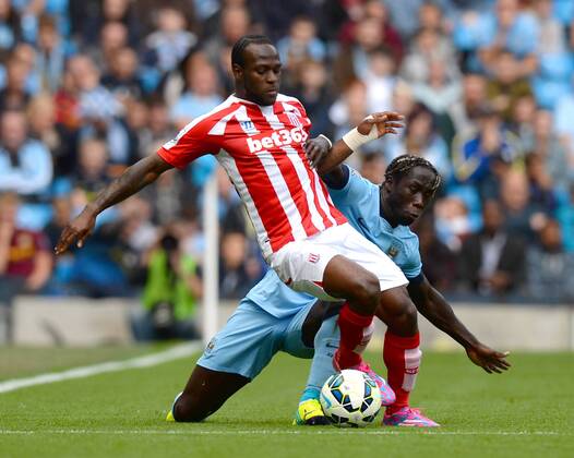 Victor Moses of Stoke City tussles with Bacary Sagna of Manchester City - Barclays Premier League - Manchester City vs Stoke City - Etihad Stadium - Manchester - England - 30th August 2014 - Picture Simon Bellis Sportimage EDITORIAL USE ONLY. No use with unauthorised audio, video, data, fixture lists, club league logos or live services. Online in-match use limited to 120 images, no video emulation. No use in betting, games or single club league player publications.