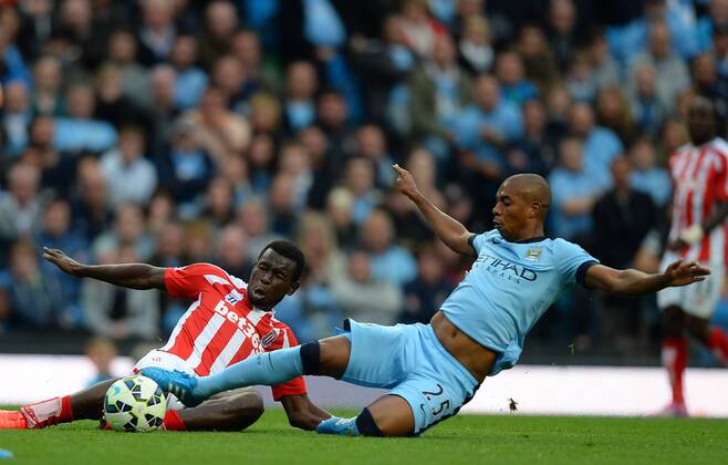 Mame Diouf of Stoke City tackles with Fernandinho of Manchester City - Barclays Premier League - Manchester City vs Stoke City - Etihad Stadium - Manchester - England - 30th August 2014 - Picture Simon Bellis Sportimage EDITORIAL USE ONLY. No use with unauthorised audio, video, data, fixture lists, club league logos or live services. Online in-match use limited to 120 images, no video emulation. No use in betting, games or single club league player publications.