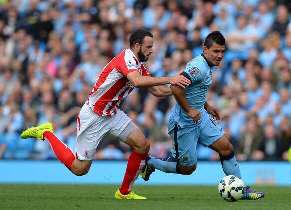 Marc Wilson of Stoke City chases after Sergio Aguero of Manchester City - Barclays Premier League - Manchester City vs Stoke City - Etihad Stadium - Manchester - England - 30th August 2014 - Picture Simon Bellis Sportimage EDITORIAL USE ONLY. No use with unauthorised audio, video, data, fixture lists, club league logos or live services. Online in-match use limited to 120 images, no video emulation. No use in betting, games or single club league player publications.