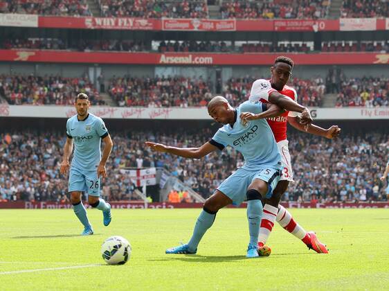 Arsenal s Danny Welbeck tussles with Manchester City s Fernadinho to fire in a shot - Barclays Premier League - Arsenal v Manchester City - Emirates Stadium - England - 13th September 2014 - Picture David Klein Sportimage EDITORIAL USE ONLY. No use with unauthorised audio, video, data, fixture lists, club league logos or live services. Online in-match use limited to 120 images, no video emulation. No use in betting, games or single club league player publications.