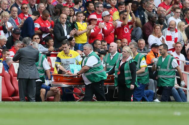 Arsenal s Mathieu Debuchy goes off injured - Barclays Premier League - FC Arsenal London v Manchester City - Emirates Stadium - England - 13th September 2014 -EDITORIAL USE ONLY. No use with unauthorised audio, video, data, fixture lists, club league logos or live services. Online in-match use limited to 120 images, no video emulation. No use in betting, games or single club league player publications.