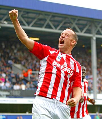 Football - 2014 2015 Premier League - Queens Park Rangers vs. Stoke City Charlie Adam of Stoke City celebrates Stokes second goal at Loftus Road Stadium with the traveling fans Colorsport Shaun Boggust 