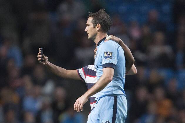 A fan runs on the pitch to try and take a selfie with Frank Lampard of Manchester City - Manchester City vs. Sheffield Wednesday - Capital One League Cup - Anfield - Liverpool - 24 09 2014 EDITORIAL USE ONLY. No use with unauthorised audio, video, data, fixture lists, club league logos or live services. Online in-match use limited to 120 images, no video emulation. No use in betting, games or single club league player publications.