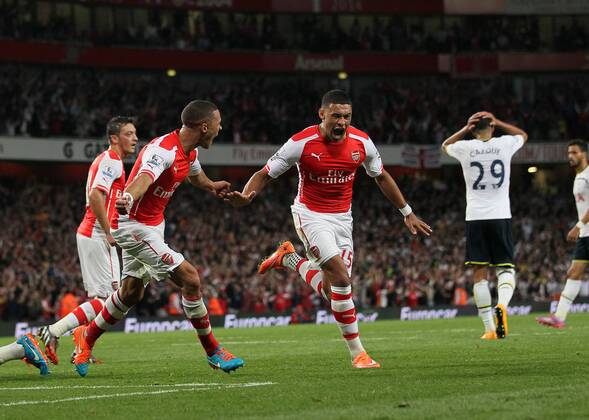 Arsenal s Alex Oxlade-Chamberlain celebrates scoring his sides opening goal - Barclays Premier League - Arsenal vs Tottenham Hotspur - Emirates Stadium - England - 27th September 2014 - EDITORIAL USE ONLY. No use with unauthorised audio, video, data, fixture lists, club league logos or live services. Online in-match use limited to 120 images, no video emulation. No use in betting, games or single club league player publications.
