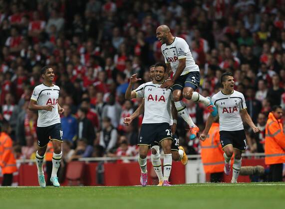 Tottenham s Nacer Chadli celebrates scoring his sides opening goal - Barclays Premier League - Arsenal vs Tottenham Hotspur - Emirates Stadium - England - 27th September 2014 - EDITORIAL USE ONLY. No use with unauthorised audio, video, data, fixture lists, club league logos or live services. Online in-match use limited to 120 images, no video emulation. No use in betting, games or single club league player publications.