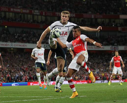 Arsenal s Alexis Sanchez tussles with Tottenham s Eric Dier - Barclays Premier League - Arsenal vs Tottenham Hotspur - Emirates Stadium - England - 27th September 2014 - EDITORIAL USE ONLY. No use with unauthorised audio, video, data, fixture lists, club league logos or live services. Online in-match use limited to 120 images, no video emulation. No use in betting, games or single club league player publications.