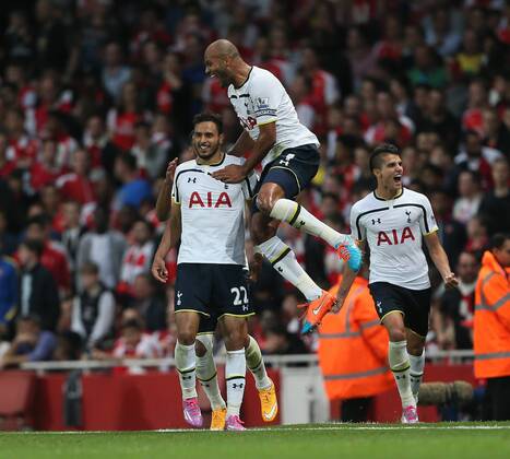 Tottenham s Nacer Chadli celebrates scoring his sides opening goal - Barclays Premier League - Arsenal vs Tottenham Hotspur - Emirates Stadium - England - 27th September 2014 - EDITORIAL USE ONLY. No use with unauthorised audio, video, data, fixture lists, club league logos or live services. Online in-match use limited to 120 images, no video emulation. No use in betting, games or single club league player publications.