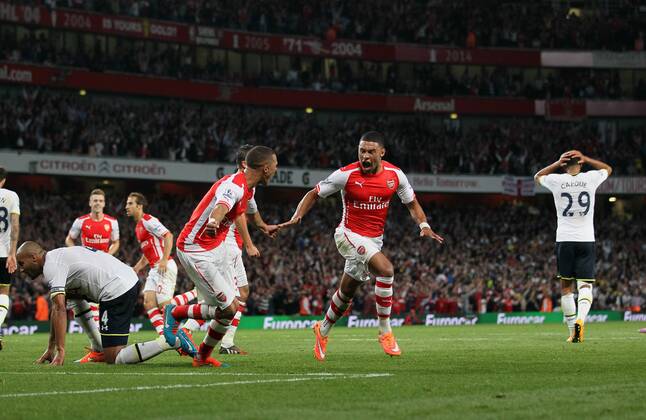 Arsenal s Alex Oxlade-Chamberlain celebrates scoring his sides opening goal - Barclays Premier League - Arsenal vs Tottenham Hotspur - Emirates Stadium - England - 27th September 2014 - EDITORIAL USE ONLY. No use with unauthorised audio, video, data, fixture lists, club league logos or live services. Online in-match use limited to 120 images, no video emulation. No use in betting, games or single club league player publications.