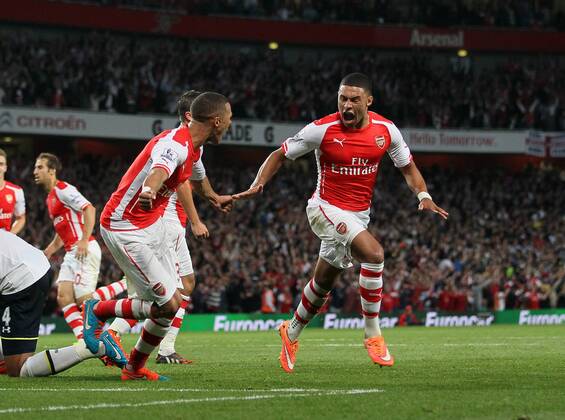 Arsenal s Alex Oxlade-Chamberlain celebrates scoring his sides opening goal - Barclays Premier League - Arsenal vs Tottenham Hotspur - Emirates Stadium - England - 27th September 2014 - EDITORIAL USE ONLY. No use with unauthorised audio, video, data, fixture lists, club league logos or live services. Online in-match use limited to 120 images, no video emulation. No use in betting, games or single club league player publications.
