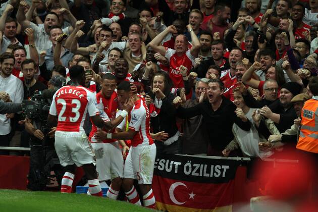 Arsenal FC London - Tottenham Hotspur Arsenal fans go wild as Alex Oxlade-Chamberlain (A) celebrates scoring a goal for Arsenal with Kieran Gibbs (A). 1-1