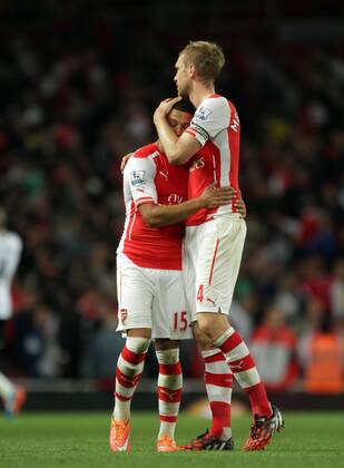 Arsenal v Tottenham Hotspur . . London, UK . . 27.09.2014 Alex Oxlade-Chamberlain (A) and Per Mertesacker (A)
