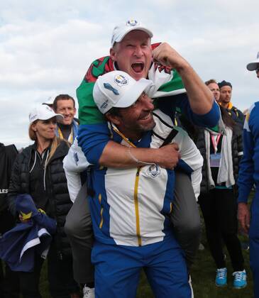 Europe s Jamie Donaldson jumps on Jose Maria Olazabal s back after securing the final point to beat USA on the final day of the 2014 Ryder Cup in Gleneagles,Scotland on September 28, 2014.  LON2014092848