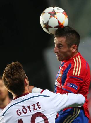 ITAR-TASS: MOSCOW REGION, RUSSIA. SEPTEMBER 30, 2014. Bayern Munich s Mario Goetze (L) as CSKA s Zoran Tosic hits the ball with his head in their UEFA Champions League Group E football match at Arena Khimki Stadium.  RE1509D6