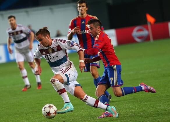 ITAR-TASS: MOSCOW REGION, RUSSIA. SEPTEMBER 30, 2014. Bayern Munich s Mario Goetze and CSKA s Zoran Tosic (L-R front) fight for the ball in their UEFA Champions League Group E football match at Arena Khimki Stadium. The game is played behind closed doors as CSKA have been punished for their fans poor behaviour in a Champions League match against Viktoria Plzen last year.  RE1509D9