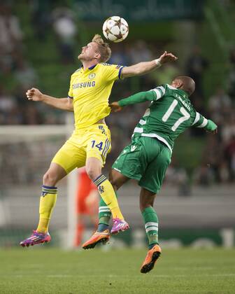 Andre Schurrle of Chelsea and Sporting s Joao Mario contest a high ball - Sporting Lisbon vs. Chelsea - UEFA Champions League - Estadio Jose Alvalade - Lisbon - 30 09 2014 Pic Philip Oldham Sportimage EDITORIAL USE ONLY. No use with unauthorised audio, video, data, fixture lists, club league logos or live services. Online in-match use limited to 120 images, no video emulation. No use in betting, games or single club league player publications.
