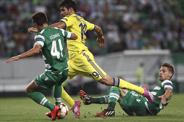 Chelsea s forward, Diego Costa (C) fights for the ball with Sporting s defender, Cedric Soares (L) and Sporting s midfielder, Adrien Silva (R) during a soccer match between Portugal s Sporting CP and England s Chelsea FC for the group stage of the UEFA Champions League, in Sporting s Alvalade Stadium in Lisbon, Portugal, on September 30, 2014. Photo by Pedro Nunes Portugal: UEFA Champions League: Sporting Vs Chelsea 