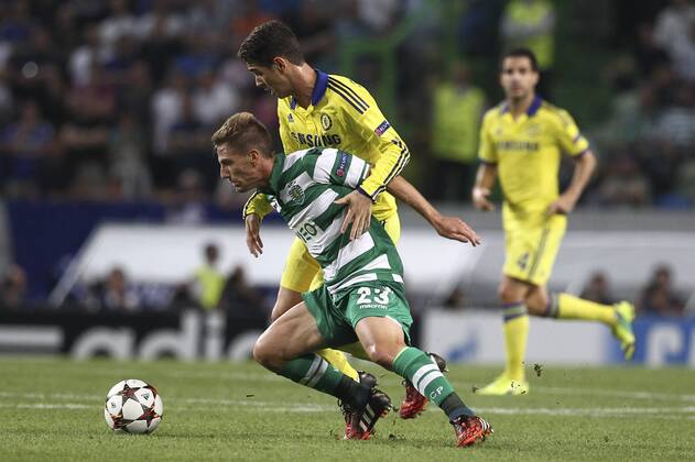 Sporting s midfielder, Adrien Silva (L) vies with Chelsea s midfielder, Oscar (R) during a soccer match between Portugal s Sporting CP and England s Chelsea FC for the group stage of the UEFA Champions League, in Sporting s Alvalade Stadium in Lisbon, Portugal, on September 30, 2014. Photo by Pedro Nunes Portugal: UEFA Champions League: Sporting Vs Chelsea 