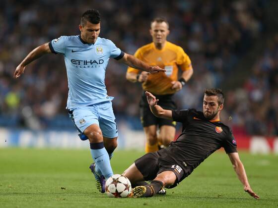 Miralem Pjanic of Roma tackles Sergio Aguero of Manchester City - UEFA Champions League group E - Manchester City vs Roma - Etihad Stadium - Manchester - England - 30th September 2014 - Picture Simon Bellis Sportimage EDITORIAL USE ONLY. No use with unauthorised audio, video, data, fixture lists, club league logos or live services. Online in-match use limited to 120 images, no video emulation. No use in betting, games or single club league player publications.