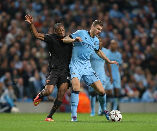 Edin Dzeko of Manchester City tussles with Seydou Keita of Roma - UEFA Champions League group E - Manchester City vs Roma - Etihad Stadium - Manchester - England - 30th September 2014 - Picture Simon Bellis Sportimage EDITORIAL USE ONLY. No use with unauthorised audio, video, data, fixture lists, club league logos or live services. Online in-match use limited to 120 images, no video emulation. No use in betting, games or single club league player publications.
