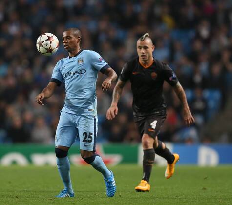 Fernandinho of Manchester City and Radja Nainggolan of Roma - UEFA Champions League group E - Manchester City vs Roma - Etihad Stadium - Manchester - England - 30th September 2014 - Picture Simon Bellis Sportimage EDITORIAL USE ONLY. No use with unauthorised audio, video, data, fixture lists, club league logos or live services. Online in-match use limited to 120 images, no video emulation. No use in betting, games or single club league player publications.