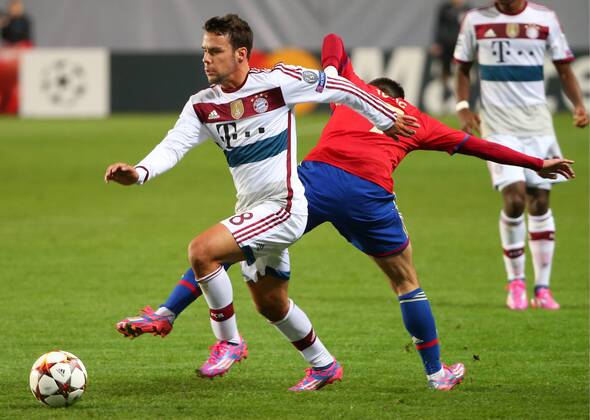 MOSCOW REGION, RUSSIA. SEPTEMBER 30, 2014. Bayern s Juan Bernat (L) and CSKA s Zoran Tosic fight for the ball in their UEFA Champions League Group E football match at Arena Khimki Stadium. The game is played behind closed doors as CSKA have been punished for their fans poor behaviour in a Champions League match against Viktoria Plzen last year. FC Bayern won the game 1:0. Valery Sharifulin TASS  RE150A0A