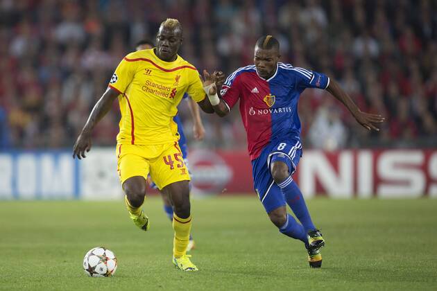 Mario Balotelli of Liverpool battles Serey Die of Basel - FC Basel vs. Liverpool - UEFA Champions League - St Jakobs Park - Basel - 01 10 2014 Pic Philip Oldham Sportimage EDITORIAL USE ONLY. No use with unauthorised audio, video, data, fixture lists, club league logos or live services. Online in-match use limited to 120 images, no video emulation. No use in betting, games or single club league player publications.