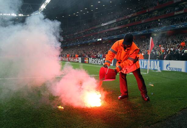 Galatasaray Istanbul fans throw flares onto the pitch after going 2-0 down - UEFA Champions League Group D - Galatasaray Istanbul - Emirates Stadium - England - 01st October 2014 - EDITORIAL USE ONLY. No use with unauthorised audio, video, data, fixture lists, club league logos or live services. Online in-match use limited to 120 images, no video emulation. No use in betting, games or single club league player publications.