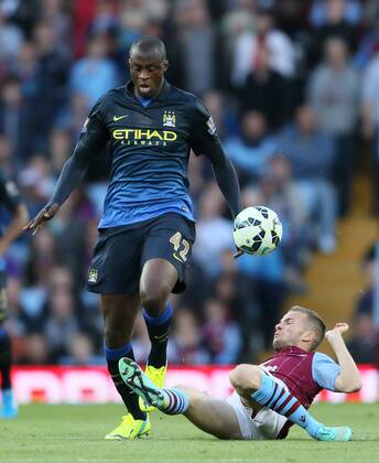 Yaya Toure of Manchester City tackled by Tom Cleverley of Aston Villa - Barclays Premier League - Aston Villa vs Manchester City - - England - 4th October 2014 - Picture SimonxBellis Sportimage EDITORIAL USE ONLY. No use with unauthorised audio, video, data, fixture lists, club league logos or live services. Online in-match use limited to 120 images, no video emulation. No use in betting, games or single club league player publications.