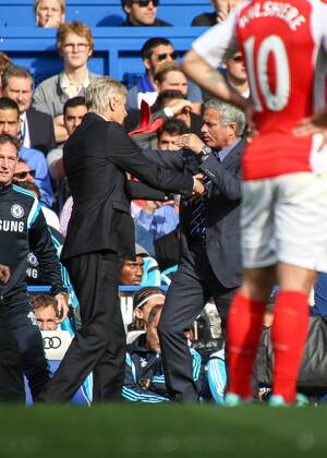 Football - 2014 2015 Premier League - Chelsea vs. Arsenal Jose Mourinho, Manager, of Chelsea FC ans Arsene Wenger,Manager, of Arsenal FC get physical at Stamford Bridge Colorsport Daniel Bearham  CHE_ARS