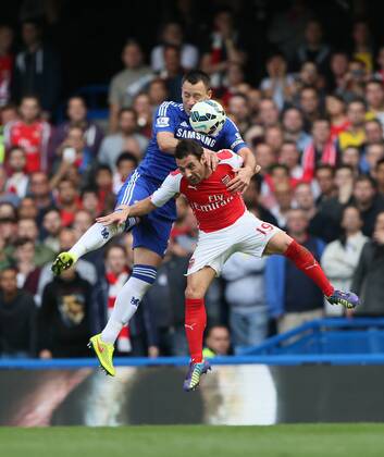 Chelsea s John Terry tussles with Arsenal s Santi Cazorla - Barclays Premier League - Chelsea Vs Arsenal - Stamford Bridge - England - 5th October 2014 - EDITORIAL USE ONLY. No use with unauthorised audio, video, data, fixture lists, club league logos or live services. Online in-match use limited to 120 images, no video emulation. No use in betting, games or single club league player publications.