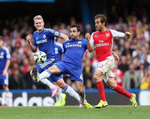 Chelsea s Cesc Fabregas tussles with Arsenal s Mathieu Flamini - Barclays Premier League - Chelsea Vs Arsenal - Stamford Bridge - England - 5th October 2014 - EDITORIAL USE ONLY. No use with unauthorised audio, video, data, fixture lists, club league logos or live services. Online in-match use limited to 120 images, no video emulation. No use in betting, games or single club league player publications.