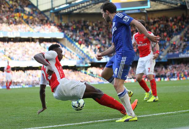 Arsenal s Danny Welbeck goes in with studs up on Chelsea s Cesc Fabregas but is only booked - Barclays Premier League - Chelsea Vs Arsenal - Stamford Bridge - England - 5th October 2014 - EDITORIAL USE ONLY. No use with unauthorised audio, video, data, fixture lists, club league logos or live services. Online in-match use limited to 120 images, no video emulation. No use in betting, games or single club league player publications.