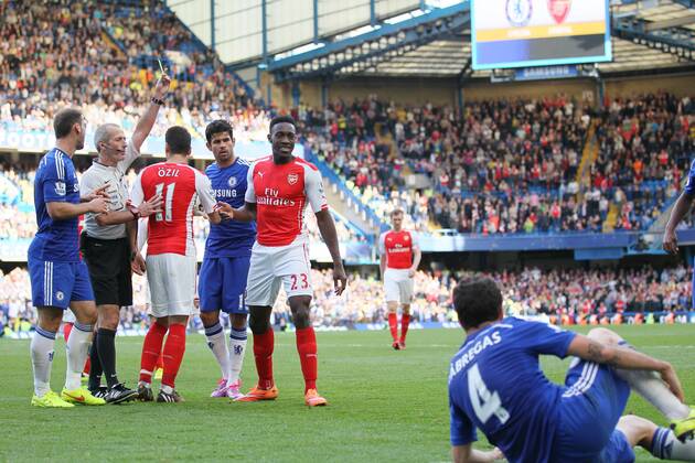 Arsenal s Danny Welbeck goes in with studs up on Chelsea s Cesc Fabregas but is only booked - Barclays Premier League - Chelsea Vs Arsenal - Stamford Bridge - England - 5th October 2014 - EDITORIAL USE ONLY. No use with unauthorised audio, video, data, fixture lists, club league logos or live services. Online in-match use limited to 120 images, no video emulation. No use in betting, games or single club league player publications.