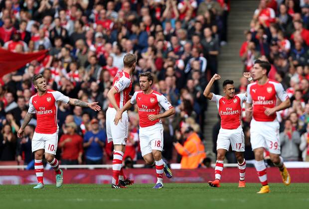 Players of Arsenal celebrate after scoring during the Barclays Premier League match between Arsenal and Hull City at Emirates Stadium on October 18, 2014 in London, England. The match ended in 2-2 draw. ) FOR EDITORIAL USE ONLY. NOT FOR SALE FOR MARKETING OR ADVERTISING CAMPAIGNS. NO USE WITH UNAUTHORIZED AUDIO, VIDEO, DATA, FIXTURE LISTS, CLUB LEAGUE LOGOS OR LIVE SERVICES. ONLINE IN-MATCH USE LIMITED TO 45 IMAGES, NO VIDEO EMULATION. NO USE IN BETTING, GAMES OR SINGLE CLUB LEAGUE PLAYER PUBLICATIONS. UK-LONDON-SOCCER-BARCLAYS PREMIER LEAGUE-ARSENAL VS HULL CITY HanxYan 