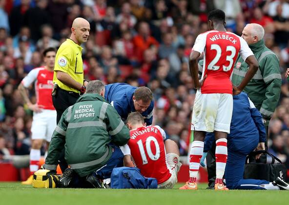 Jack Wilshere (C) of Arsenal is injured during the Barclays Premier League match between Arsenal and Hull City at Emirates Stadium on October 18, 2014 in London, England. The match ended in 2-2 draw. ) FOR EDITORIAL USE ONLY. NOT FOR SALE FOR MARKETING OR ADVERTISING CAMPAIGNS. NO USE WITH UNAUTHORIZED AUDIO, VIDEO, DATA, FIXTURE LISTS, CLUB LEAGUE LOGOS OR LIVE SERVICES. ONLINE IN-MATCH USE LIMITED TO 45 IMAGES, NO VIDEO EMULATION. NO USE IN BETTING, GAMES OR SINGLE CLUB LEAGUE PLAYER PUBLICATIONS. (SP)UK-LONDON-SOCCER-BARCLAYS PREMIER LEAGUE-ARSENAL VS HULL CITY HanxYan 