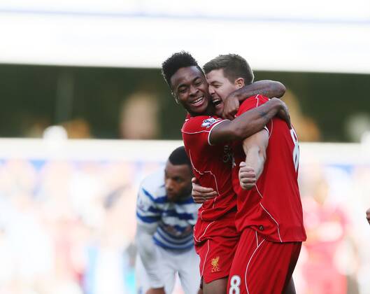 Liverpool s Raheem Sterling celebrates his sides winning goal with Steven Gerrard - Barclays Premier League - QPR vs Liverpool - Loftus Road - England - 19th October 2014 - Picture David Klein Sportimage EDITORIAL USE ONLY. No use with unauthorised audio, video, data, fixture lists, club league logos or live services. Online in-match use limited to 120 images, no video emulation. No use in betting, games or single club league player publications.