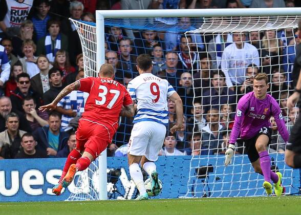 Football - 2014 2015 Premier League - Queens Park Rangers vs Liverpool, Simon Mignolet of Liverpool FC prepares to close down Charlie Austin of Queens Park Rangers at Loftus Road Colorsport Daniel Bearham QPR_LIV