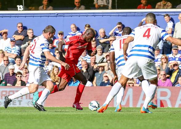 Football - 2014 2015 Premier League - Queens Park Rangers vs Liverpool, Mario Balotelli of Liverpool FC tries to find a way through the QPR defence at Loftus Road Colorsport Daniel Bearham  QPR_LIV