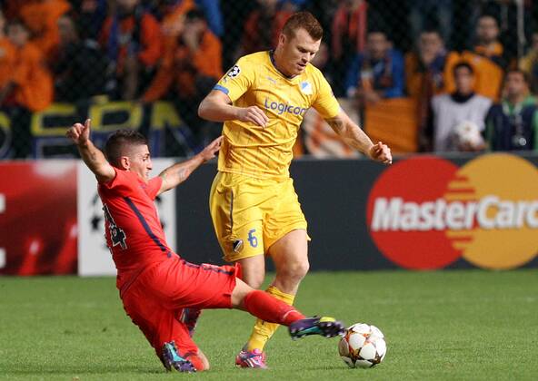 NICOSIA, Oct. 21, 2014 -- John Riise (R) of APOEL Nicosia vies for the ball during the Champions League Group F soccer match agains Paris Saint Germain at GSP Stadium in Nicosia, Cyprus, October 21, 2014. Paris Saint Germain won 1-0. ) (SP)CYPRUS-NICOSIA-UEFA-PSG VS NICOSIA SakisxSavvides 