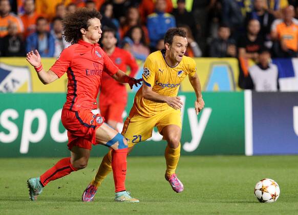 NICOSIA, Oct. 21, 2014 -- Paris Saint Germain s David Luiz (L) vies for the ball during the Champions League Group F soccer match agains APOEL Nicosia at GSP Stadium in Nicosia, Cyprus, October 21, 2014. Paris Saint Germain won 1-0. ) (SP)CYPRUS-NICOSIA-UEFA-PSG VS NICOSIA SakisxSavvides 